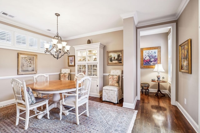 dining area with baseboards, visible vents, ornamental molding, dark wood-style flooring, and an inviting chandelier