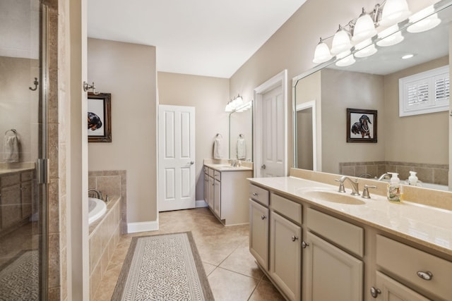 bathroom with a bath, a stall shower, a sink, and tile patterned floors