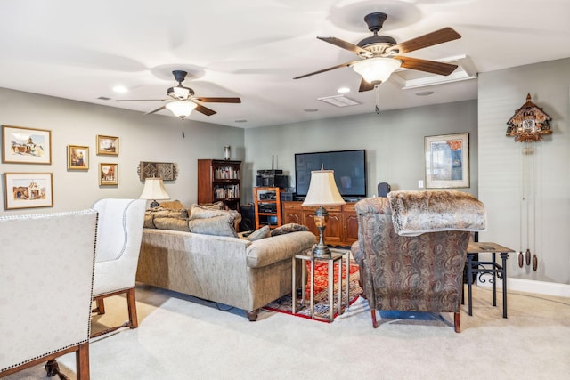 living area with a ceiling fan, light colored carpet, visible vents, and baseboards