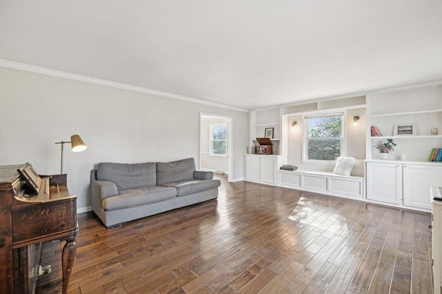 living area with ornamental molding, built in shelves, baseboards, and wood finished floors