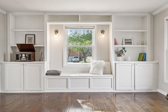 mudroom with built in shelves, wood finished floors, and crown molding