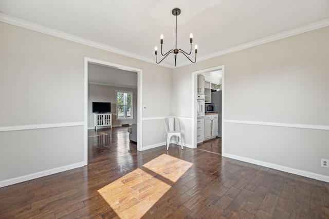 unfurnished dining area with dark wood-style floors, a chandelier, crown molding, and baseboards