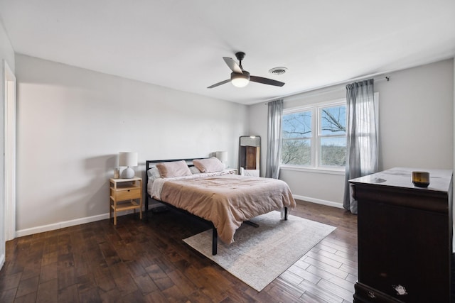 bedroom with dark wood finished floors, baseboards, and visible vents