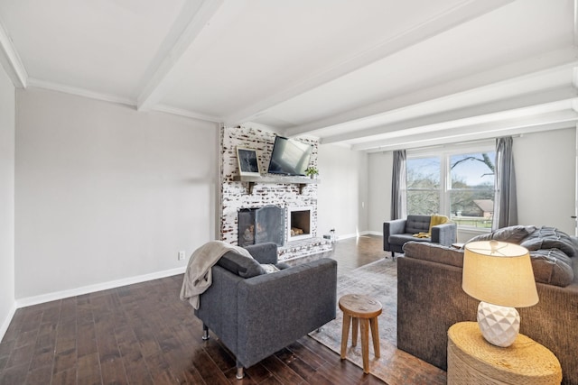 living area with baseboards, beam ceiling, wood finished floors, and a fireplace