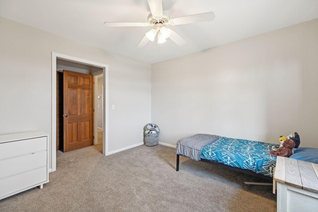 bedroom with a ceiling fan, baseboards, and carpet floors