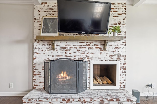 interior details featuring a fireplace, baseboards, and wood finished floors