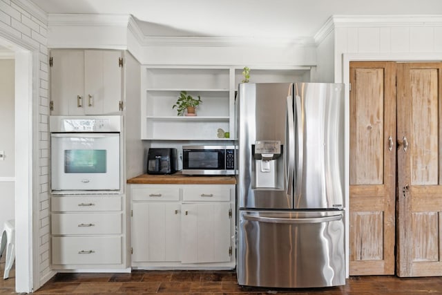 kitchen with crown molding, dark wood-style floors, and appliances with stainless steel finishes