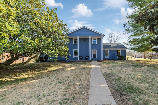 greek revival house featuring stucco siding and a front yard