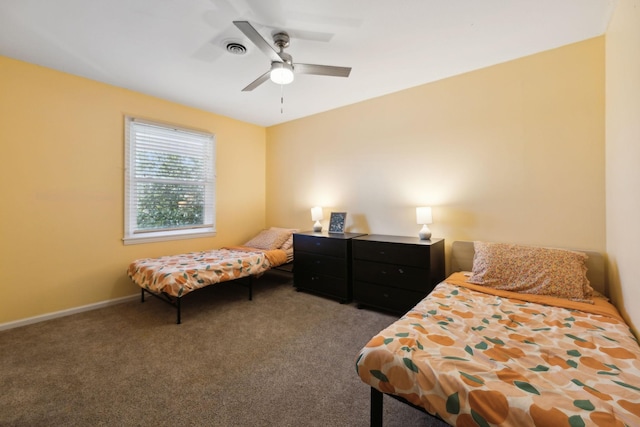 bedroom with carpet flooring, visible vents, baseboards, and ceiling fan