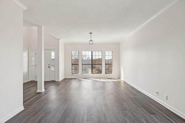 unfurnished living room featuring ornamental molding, dark wood finished floors, and baseboards