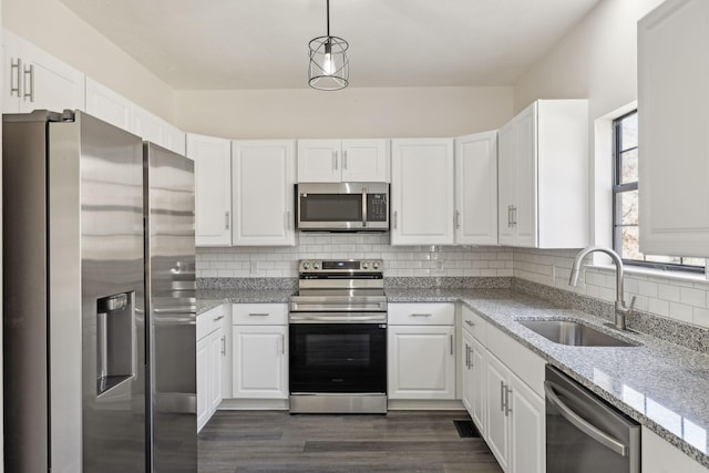 kitchen with stainless steel appliances, white cabinetry, and a sink