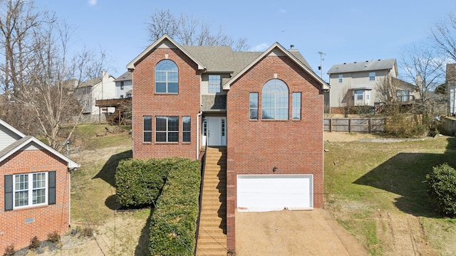 traditional-style house featuring a garage, brick siding, concrete driveway, fence, and a front yard