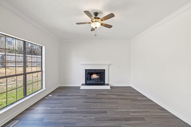 unfurnished living room featuring ornamental molding, dark wood-style flooring, visible vents, and baseboards