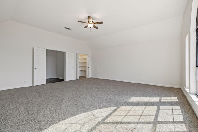 unfurnished bedroom featuring carpet, vaulted ceiling, and baseboards