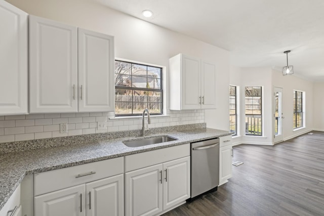 kitchen featuring tasteful backsplash, dishwasher, dark wood-style flooring, white cabinetry, and a sink