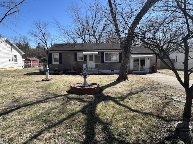 view of front of property with brick siding, crawl space, and a front yard