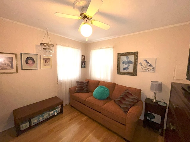 living room featuring a ceiling fan, ornamental molding, and wood finished floors