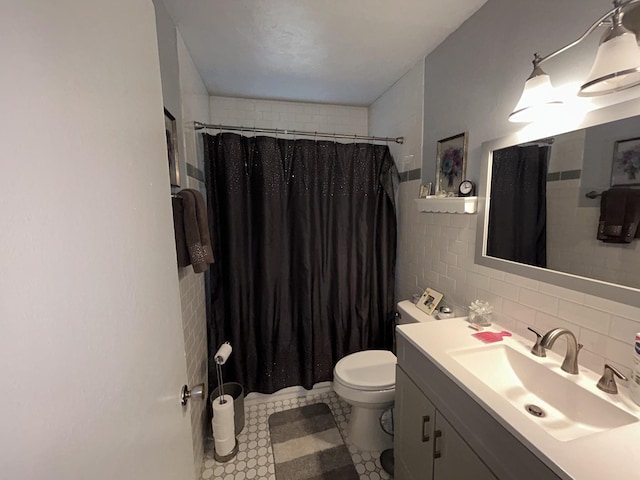 bathroom featuring toilet, curtained shower, tile walls, and vanity