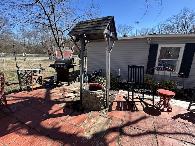 view of patio / terrace with area for grilling and fence