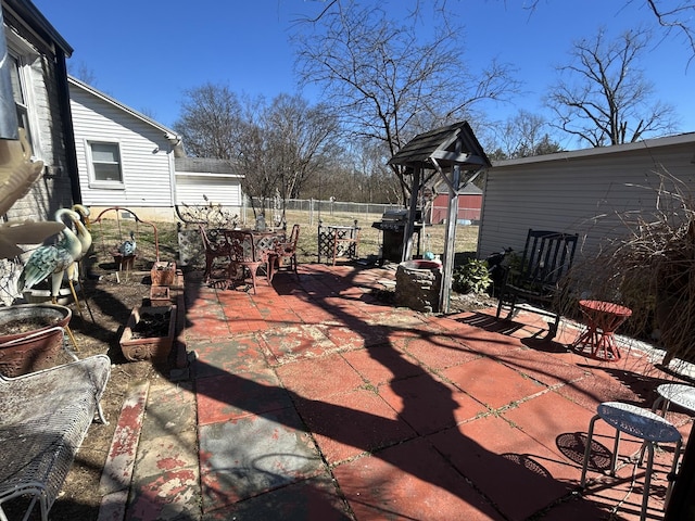 view of patio with fence, outdoor dining area, and area for grilling