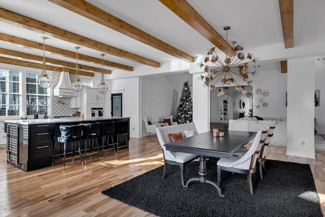 dining space with light wood-type flooring and beamed ceiling