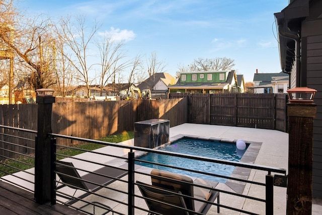 view of swimming pool featuring a fenced backyard and a jacuzzi