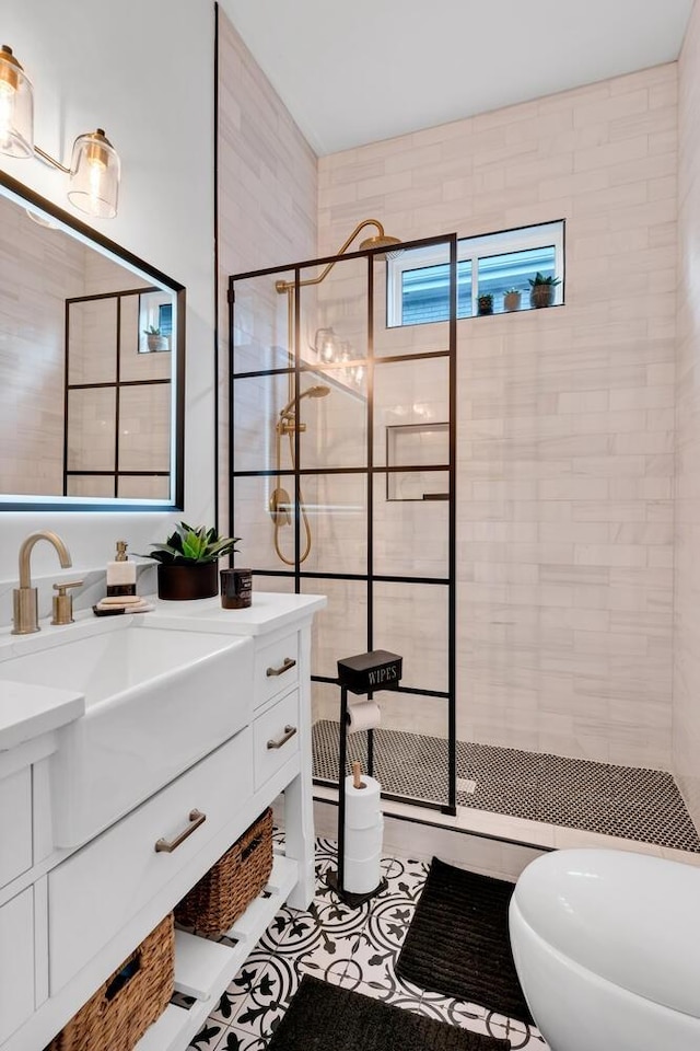 full bath featuring tile patterned flooring, walk in shower, and vanity