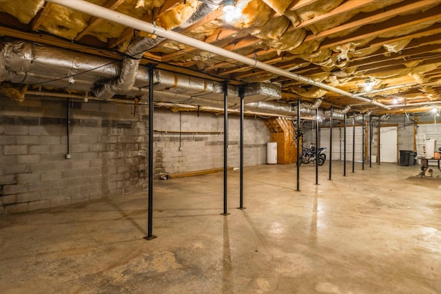 unfinished basement featuring water heater