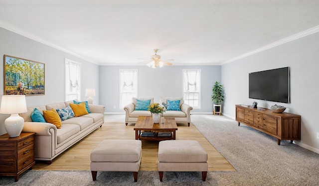 living area featuring light carpet, baseboards, and crown molding