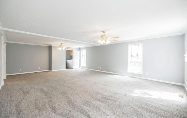 carpeted spare room featuring baseboards, a ceiling fan, and crown molding