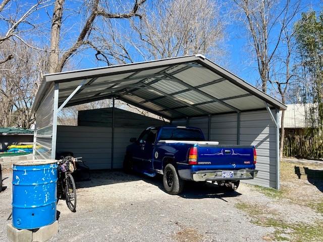 view of vehicle parking featuring driveway and a detached carport