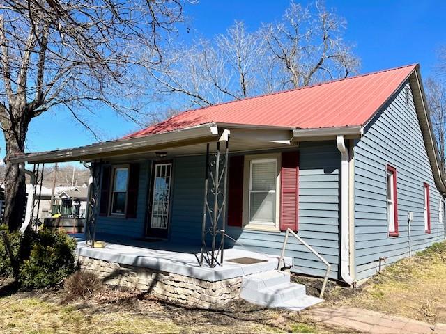 view of front of home with metal roof and a porch