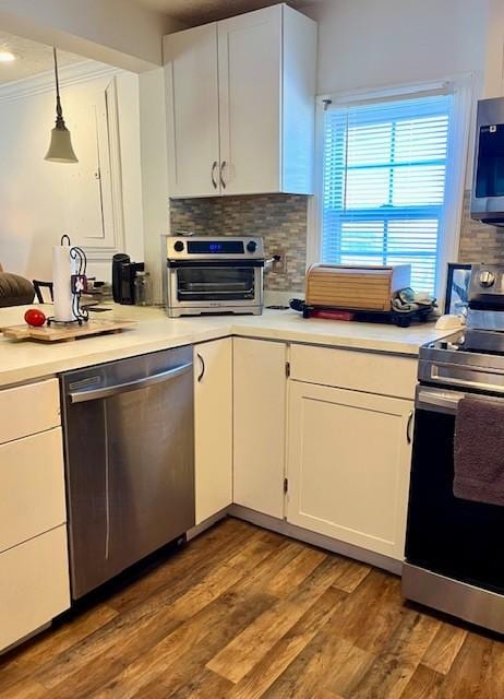 kitchen featuring tasteful backsplash, a toaster, white cabinets, wood finished floors, and stainless steel appliances