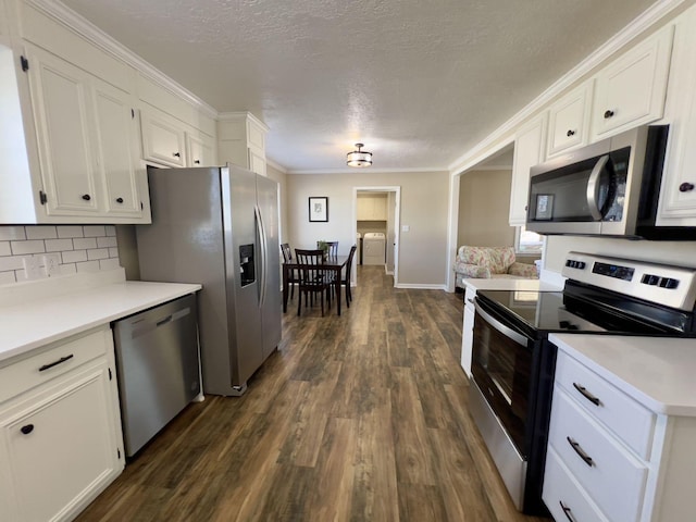 kitchen with stainless steel appliances, light countertops, dark wood-style flooring, and white cabinets