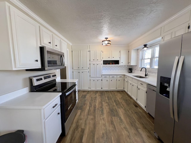 kitchen featuring dark wood-style floors, stainless steel appliances, a sink, and white cabinetry