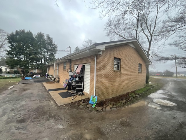 view of property exterior with brick siding