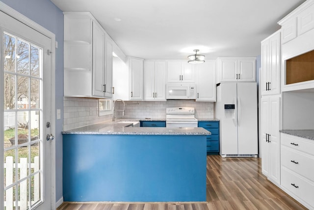 kitchen featuring white appliances, tasteful backsplash, dark wood-style flooring, open shelves, and a sink