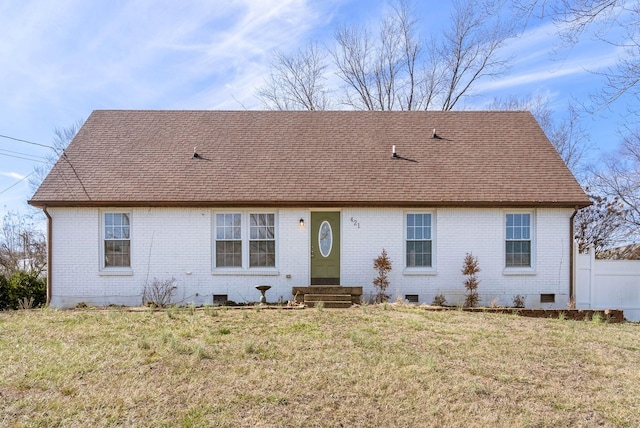 view of front of house featuring entry steps, a shingled roof, crawl space, a front lawn, and brick siding