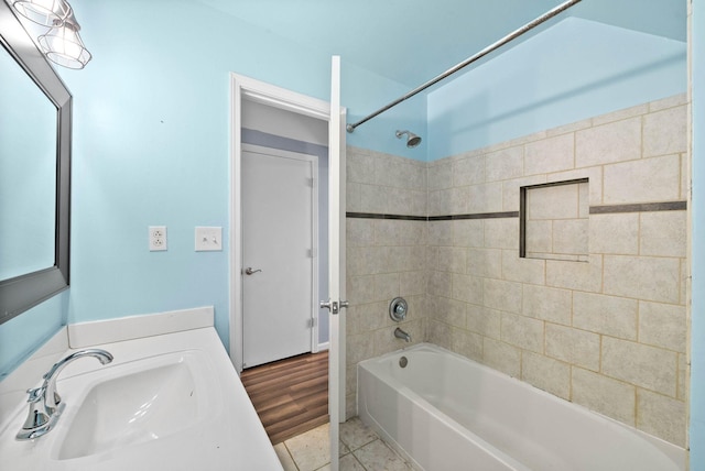 full bath with tile patterned flooring, a sink, and shower / bathing tub combination