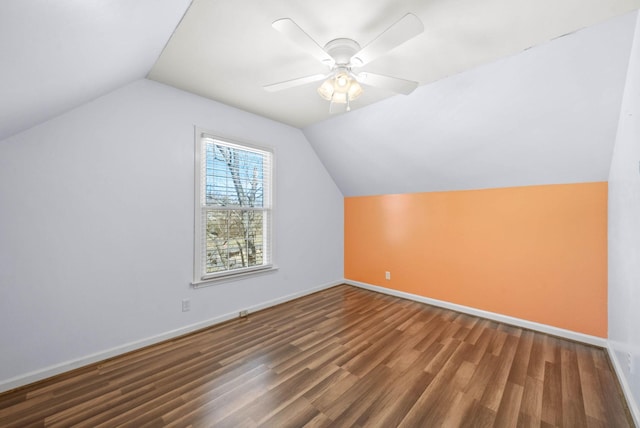 additional living space with ceiling fan, baseboards, vaulted ceiling, and wood finished floors