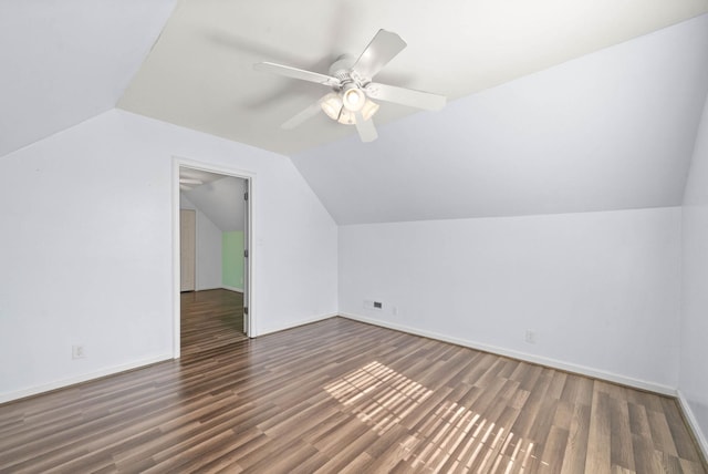 additional living space with ceiling fan, baseboards, vaulted ceiling, and wood finished floors