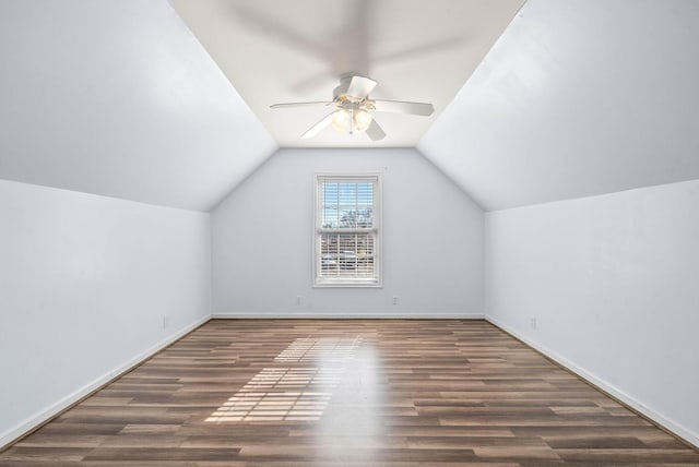 additional living space with vaulted ceiling, ceiling fan, wood finished floors, and baseboards