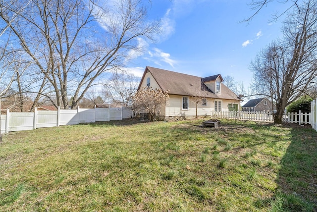 back of property featuring crawl space, a fenced backyard, and a lawn