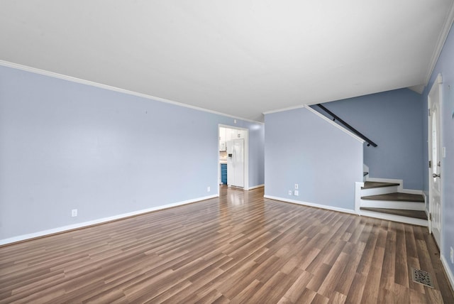 unfurnished living room with stairway, crown molding, visible vents, and wood finished floors