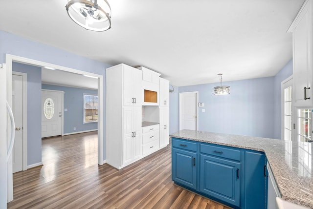 kitchen with dark wood-style floors, plenty of natural light, white cabinets, and blue cabinets