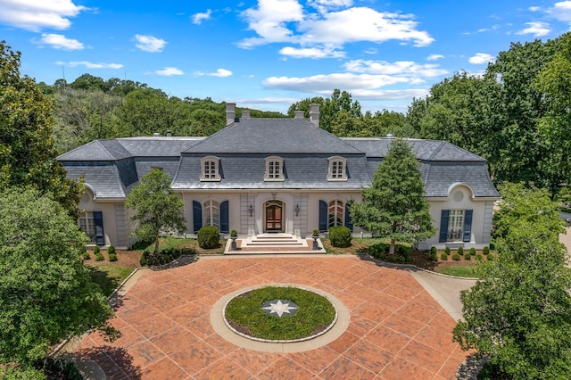 french country home featuring a chimney