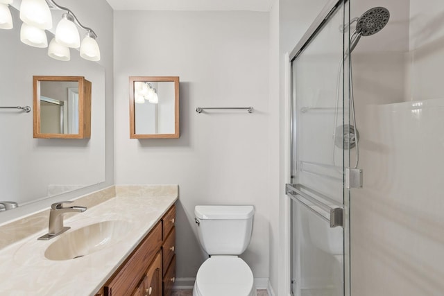 full bath featuring toilet, a shower stall, and vanity