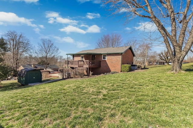 view of side of home featuring brick siding, a storage unit, a lawn, a deck, and an outdoor structure