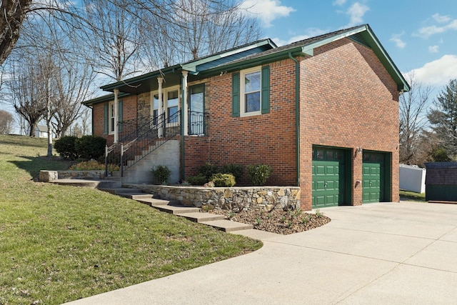 view of front of house featuring a front yard, concrete driveway, brick siding, and an attached garage