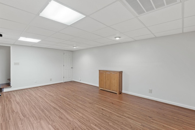 unfurnished room with a paneled ceiling, light wood-style floors, baseboards, and visible vents